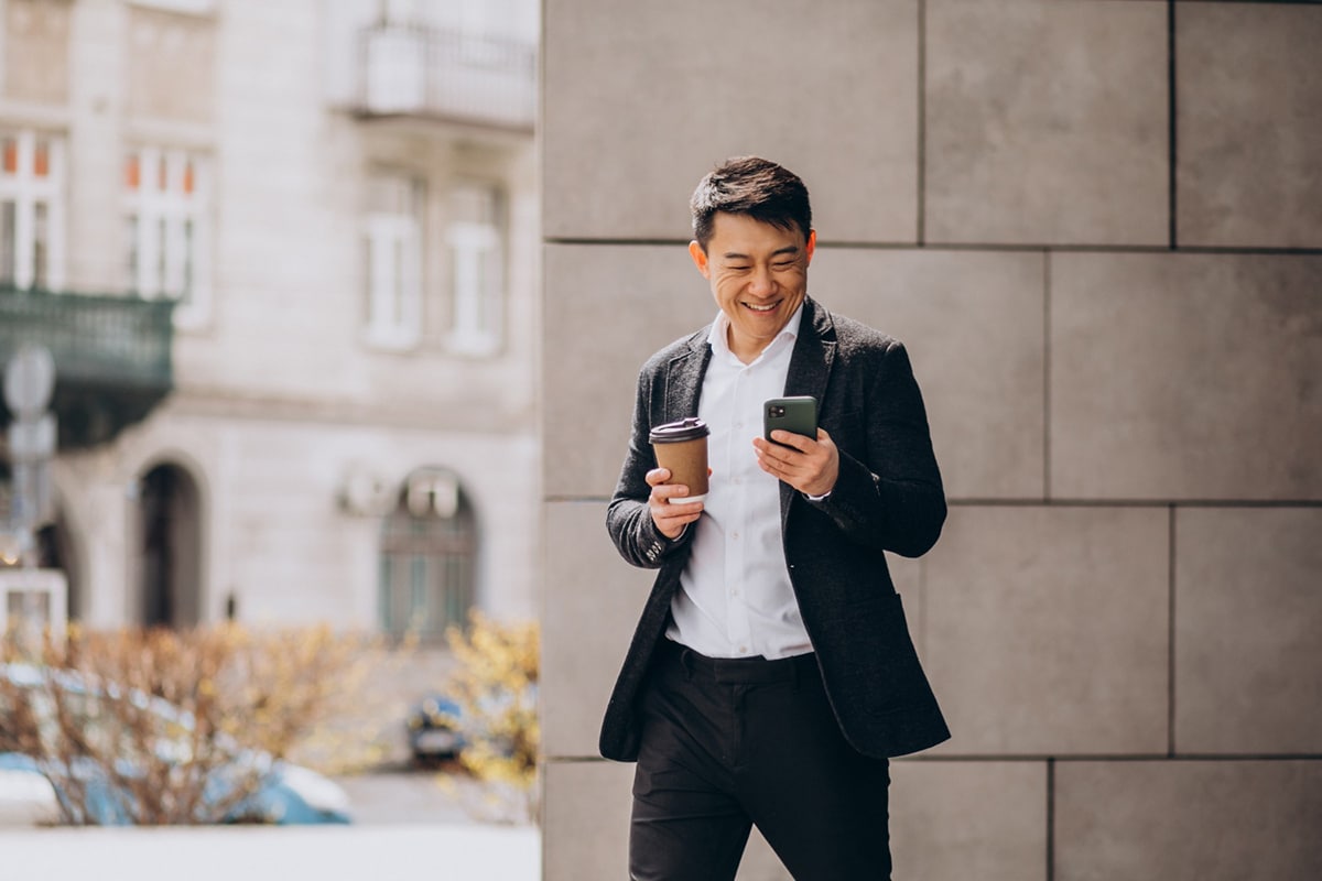 Man using his smartphone while seeking information about erectile dysfunction treatments