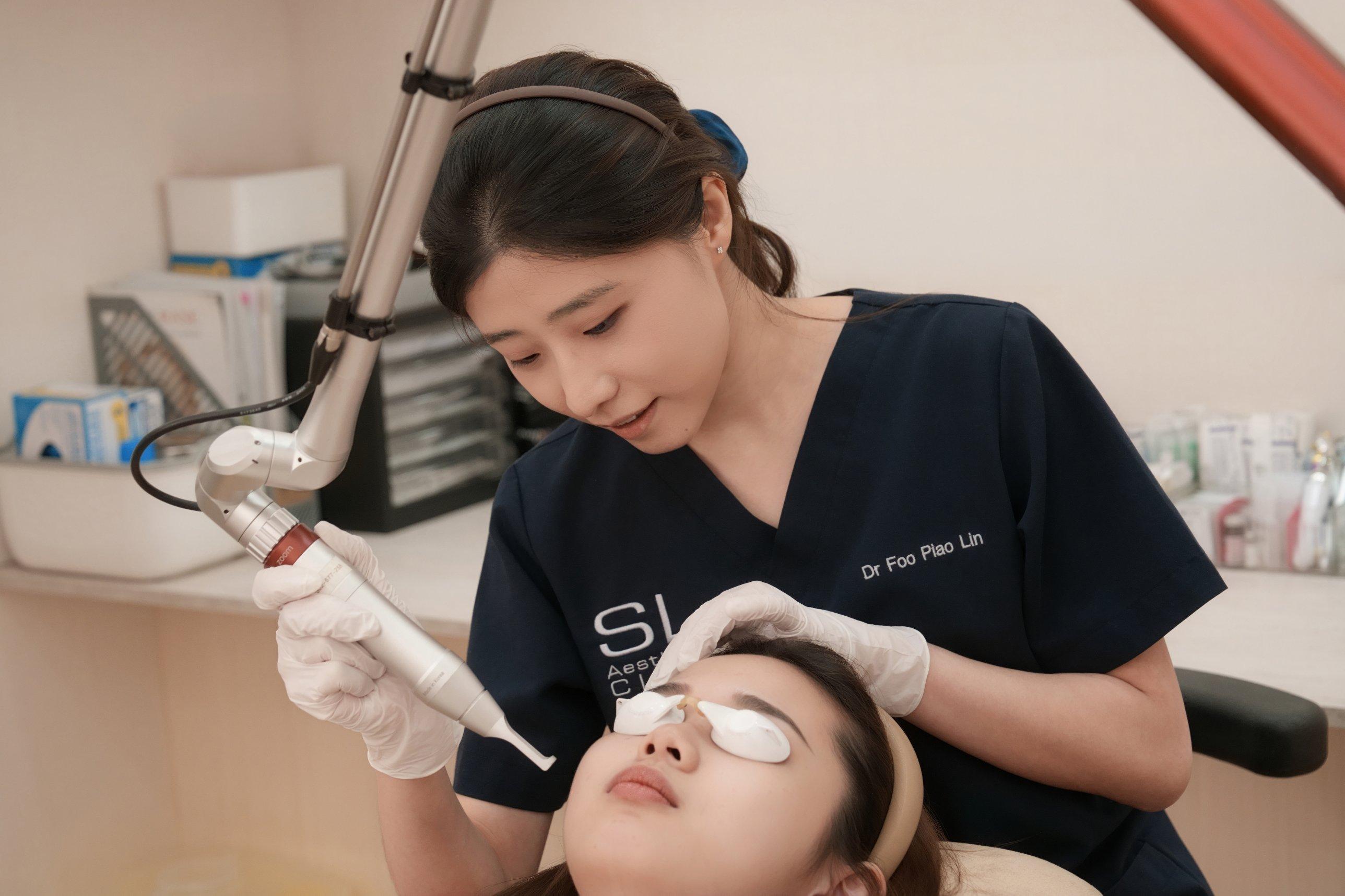A SL Aesthetic Clinic staff doing skin laser on patient